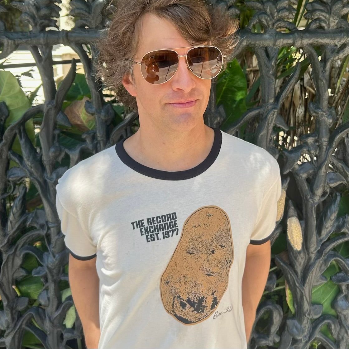 Model posing with Retro-Styled Ringer White T-Shirt with Idaho Potato design.