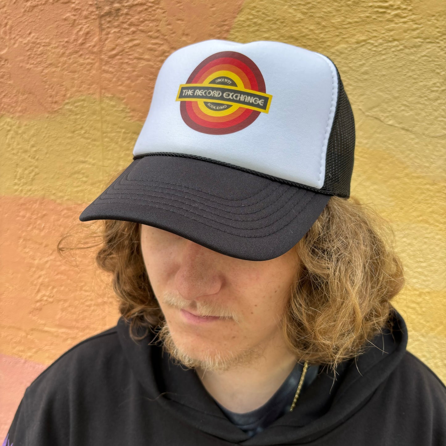 Breathable Black and White Trucker Hat featuring logo of The Record Exchange Boise Idaho.