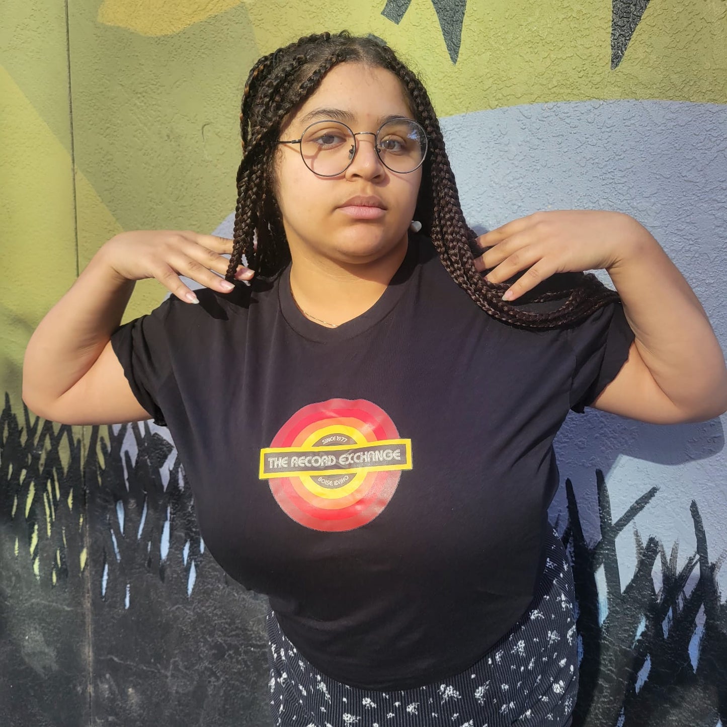 Model posing with Black T-Shirt featuring Newest Logo of The Record Exchange Boise Idaho.