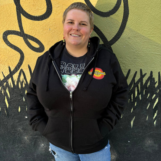 Model posing with Black Zip Up Hoodie branded with The Record Exchange Newest Logo.